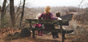 woman-sitting-on-bench-with-children